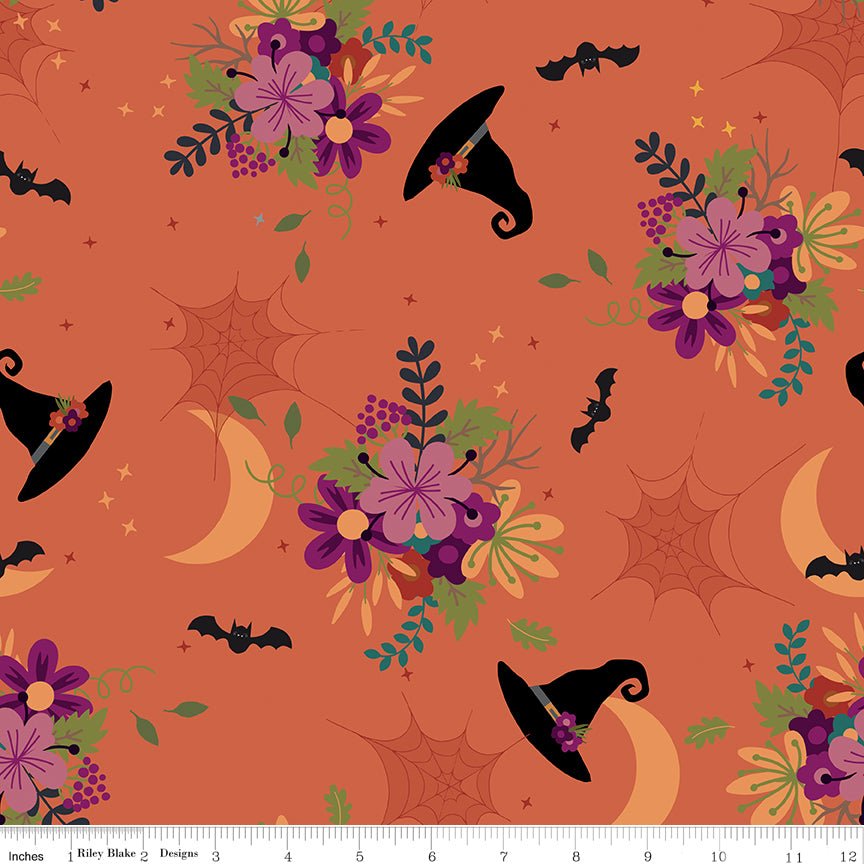 Little Witch Main Pumpkin Yardage by Jennifer Long | Riley Blake Designs orange fabric with scattered witches hats, spider webs, moons, bats, flowers, stars and more